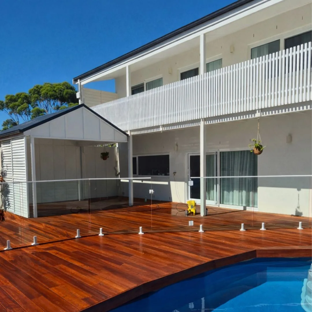 Completed exterior painting project with a freshly painted deck and pool area