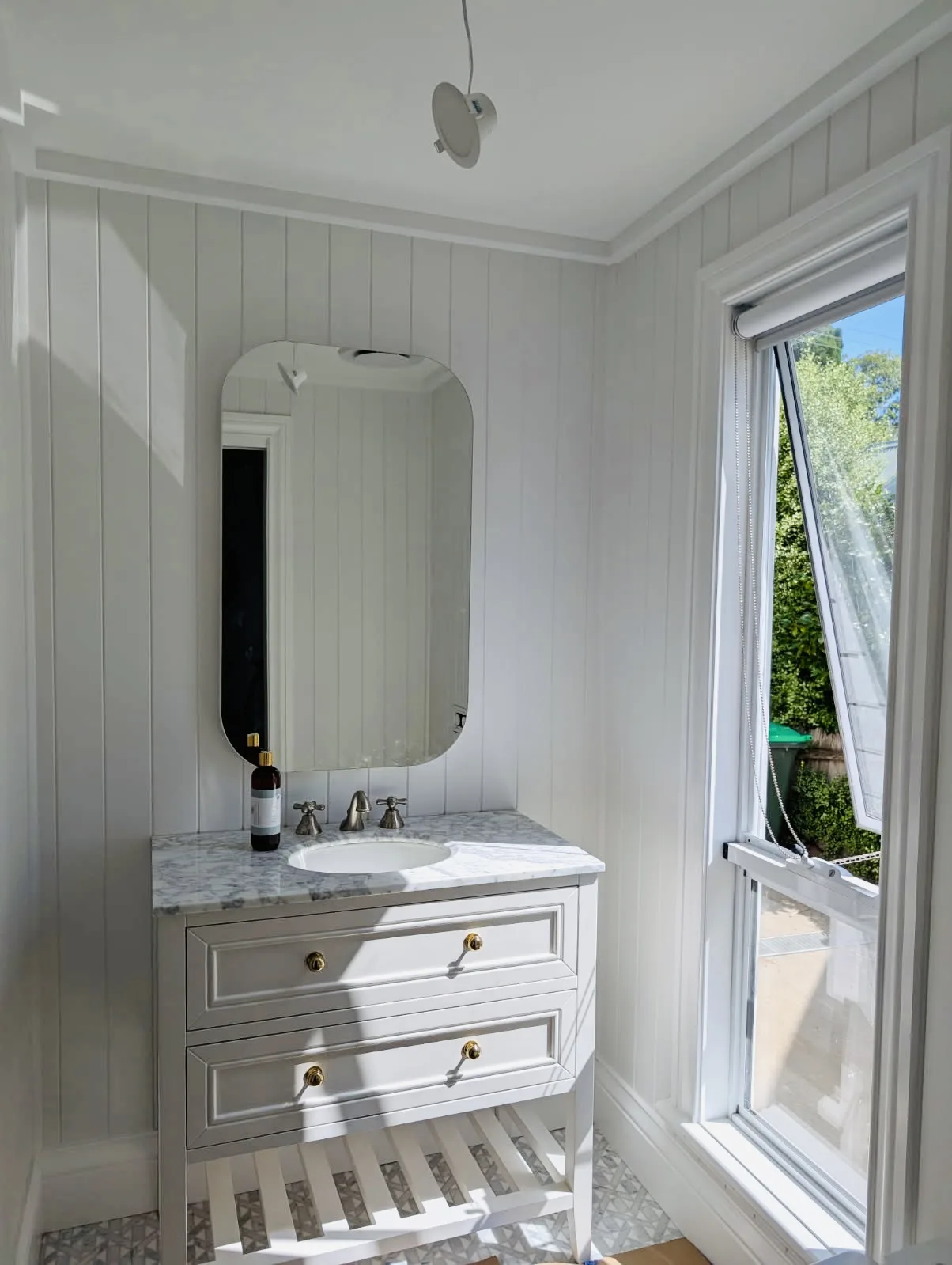 Freshly painted bathroom vanity and wall panelling