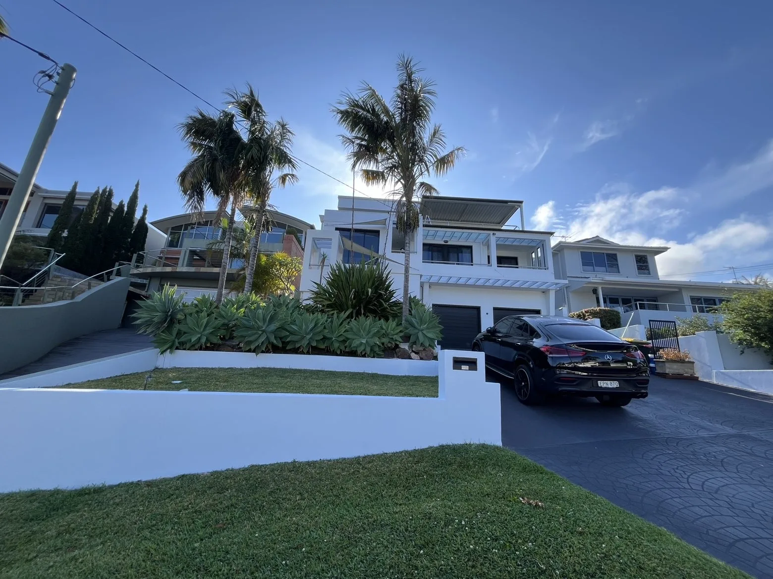 Completed residential exterior repaint with landscaped front yard