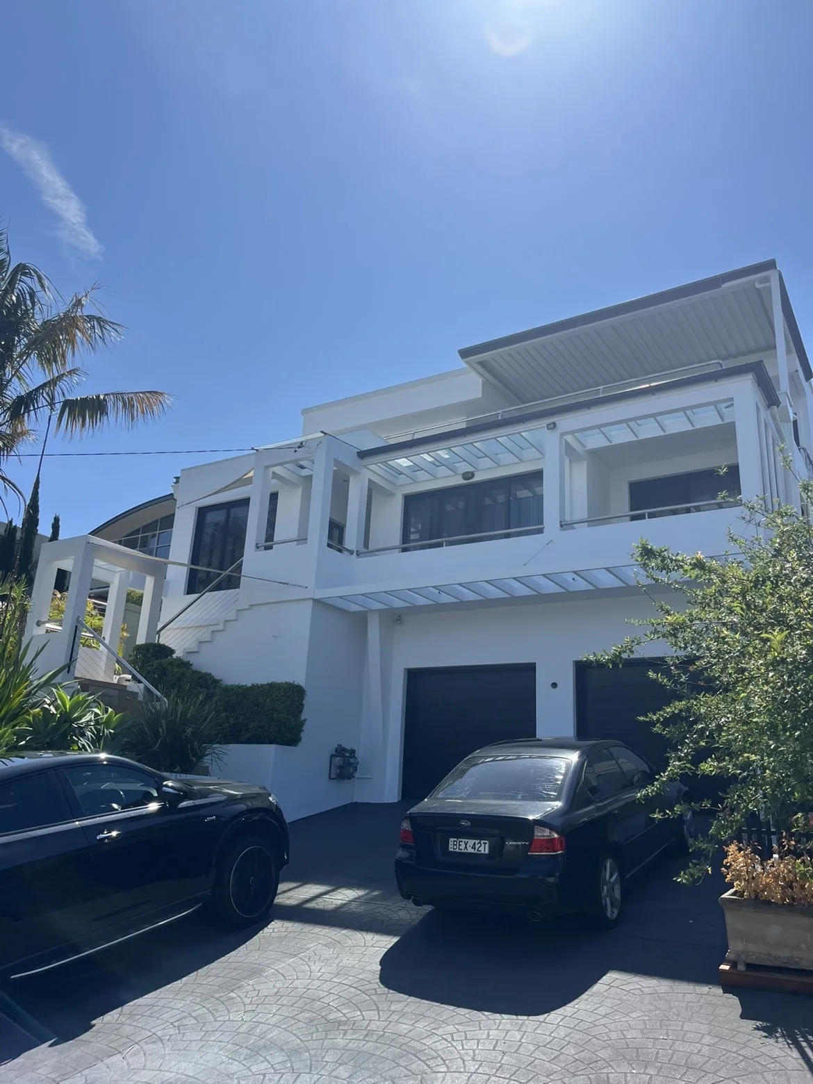Painted home exterior with deck and pool area
