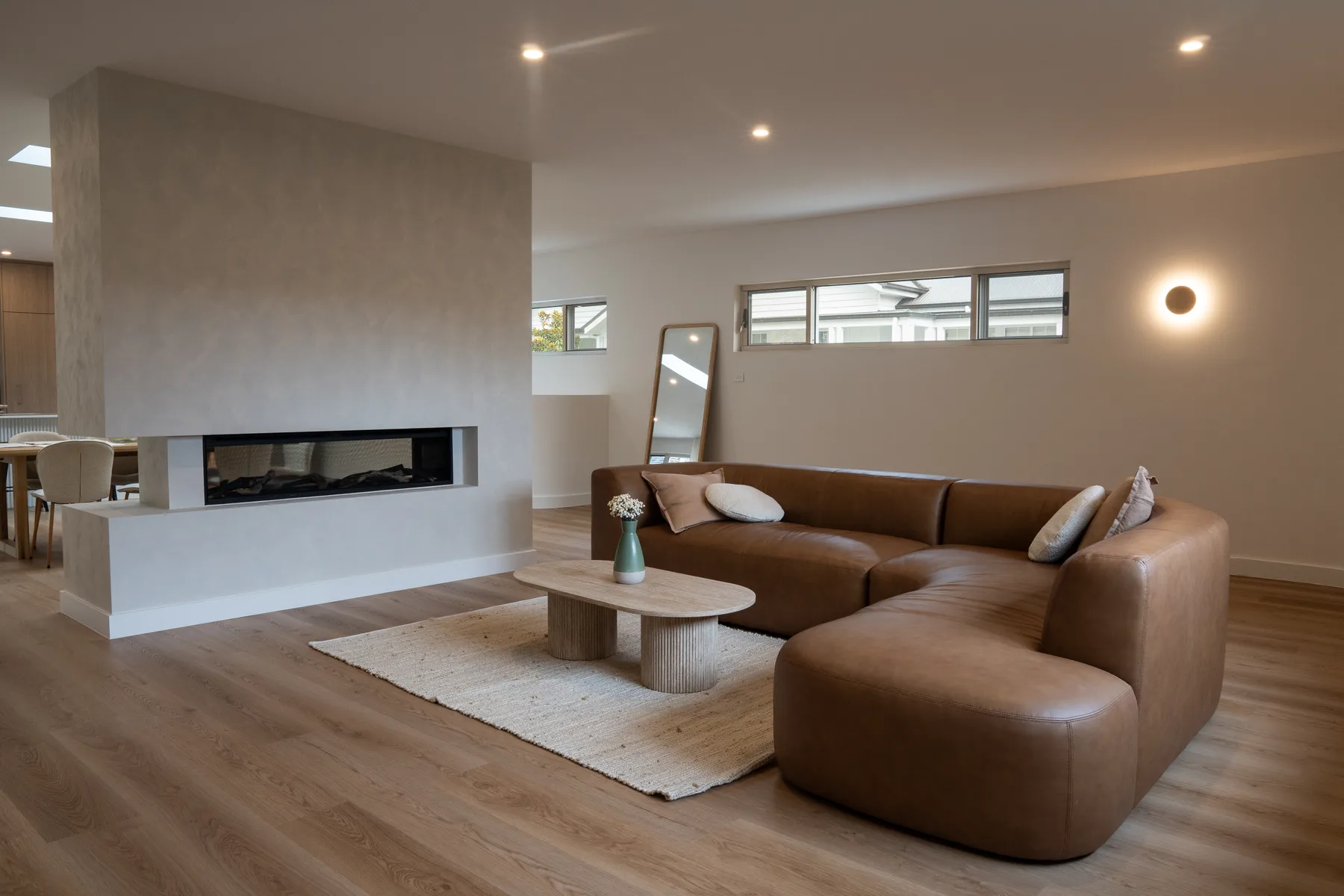 Completed living room repaint with fireplace and feature lighting