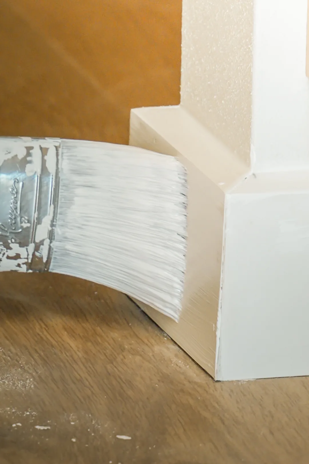 Painter applying a clean finish to interior trim